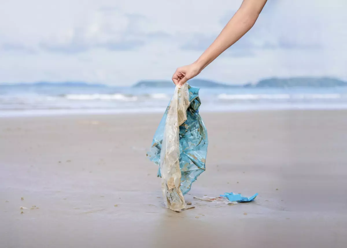 Picking up plastic waste from a beach